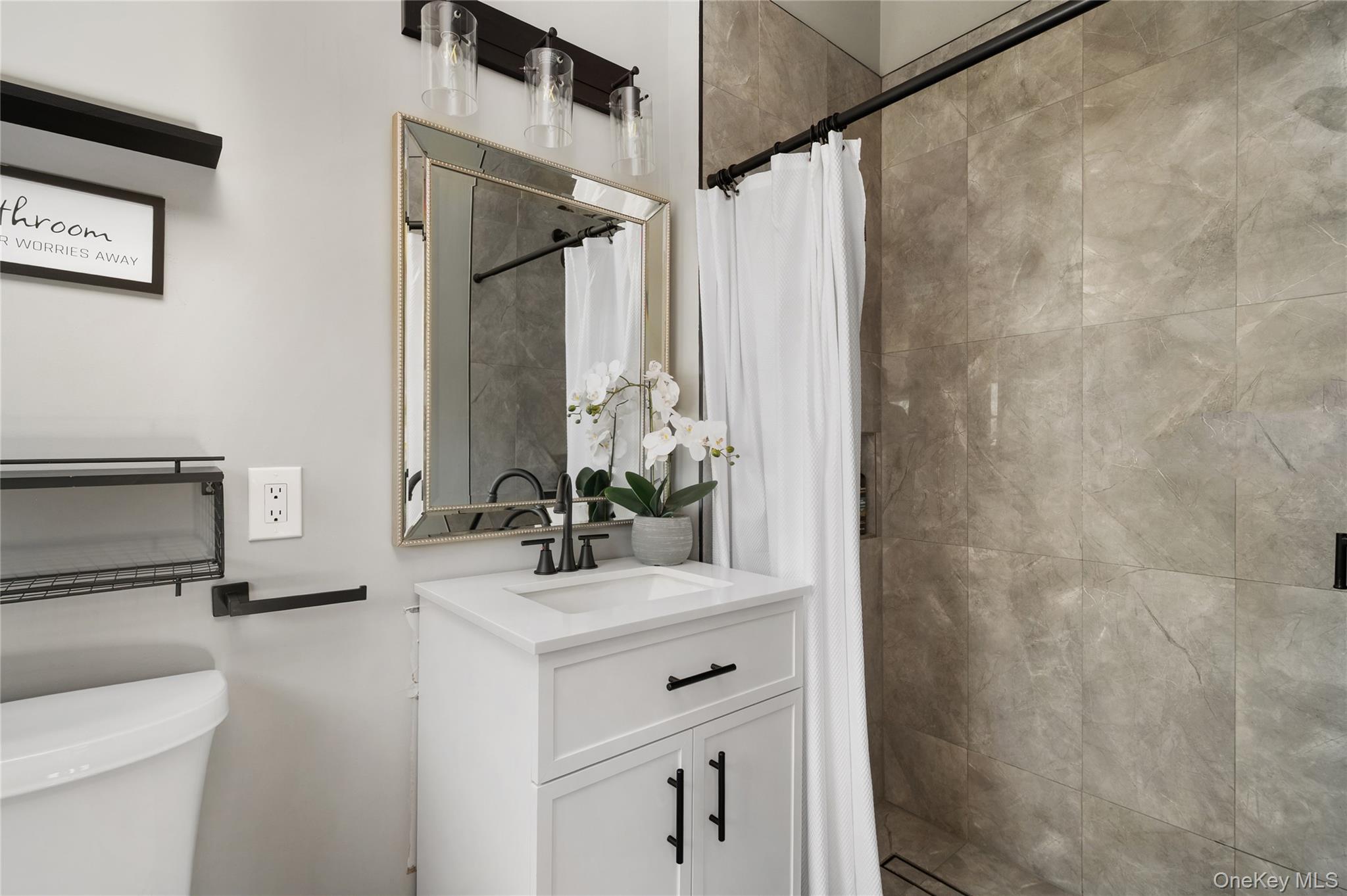 148 Exeter Road Massapequa, NY 11758 - Photo 17 of 28 a bathroom with a sink vanity granite and a mirror