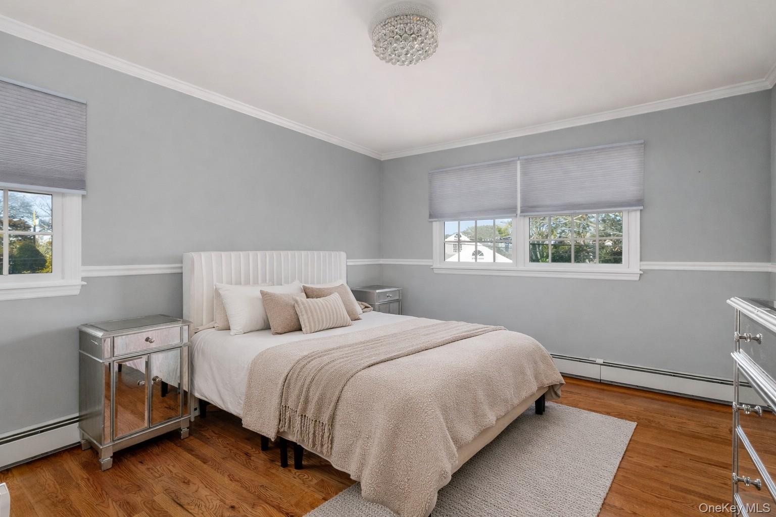 148 Exeter Road Massapequa, NY 11758 - Photo 18 of 28 a bedroom with a bed a window and potted plant