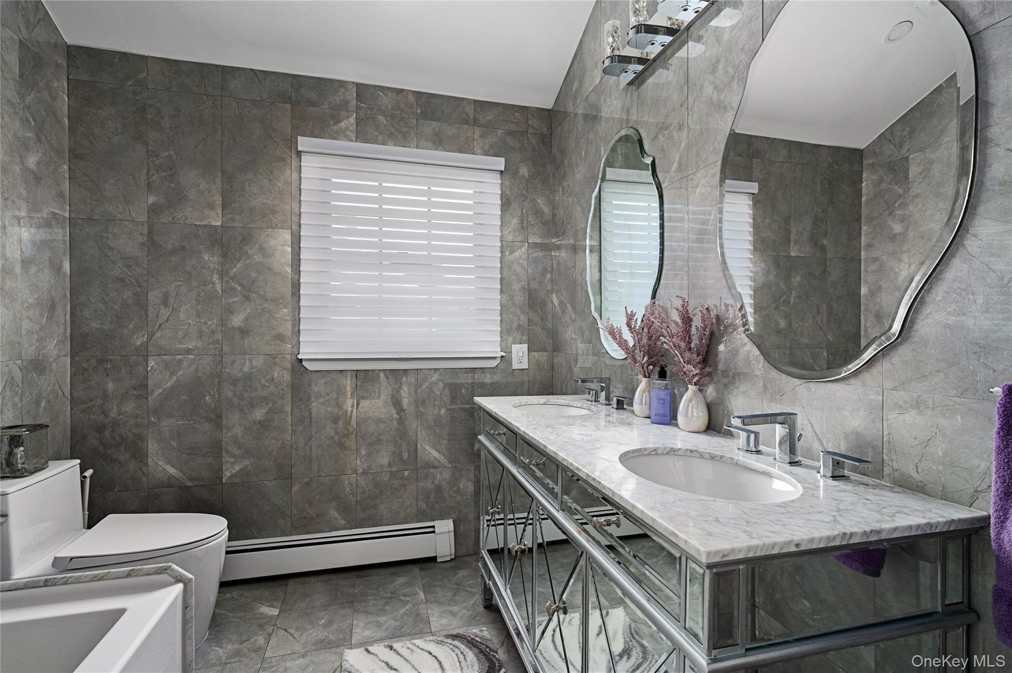 148 Exeter Road Massapequa, NY 11758 - Photo 22 of 28 a bathroom with a granite countertop sink a toilet and a mirror