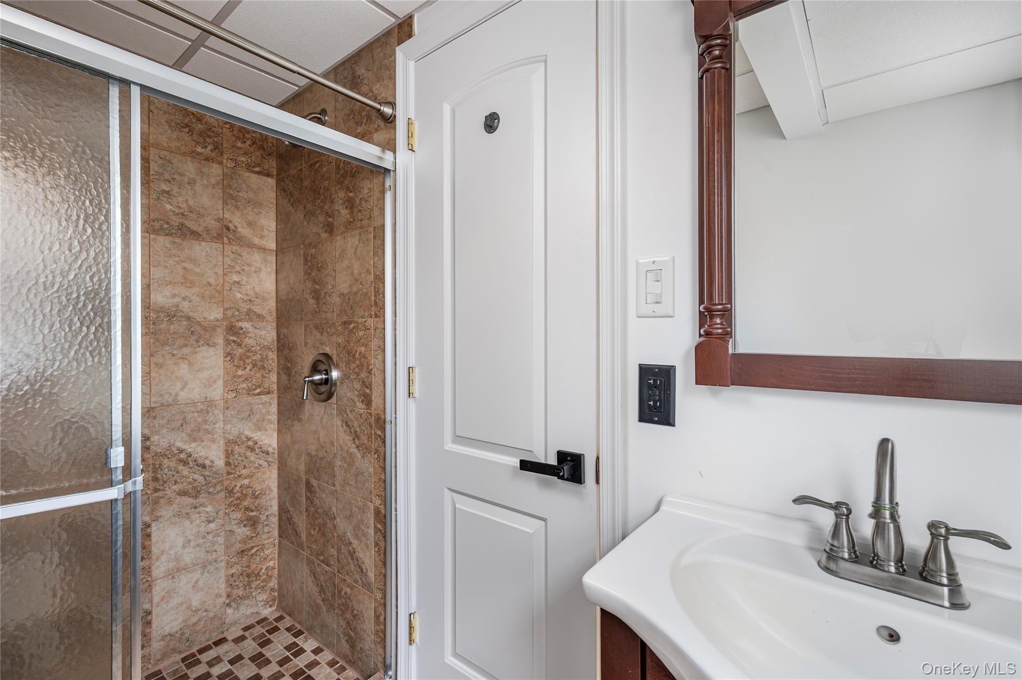 148 Exeter Road Massapequa, NY 11758 - Photo 25 of 28 a bathroom with a sink and mirror