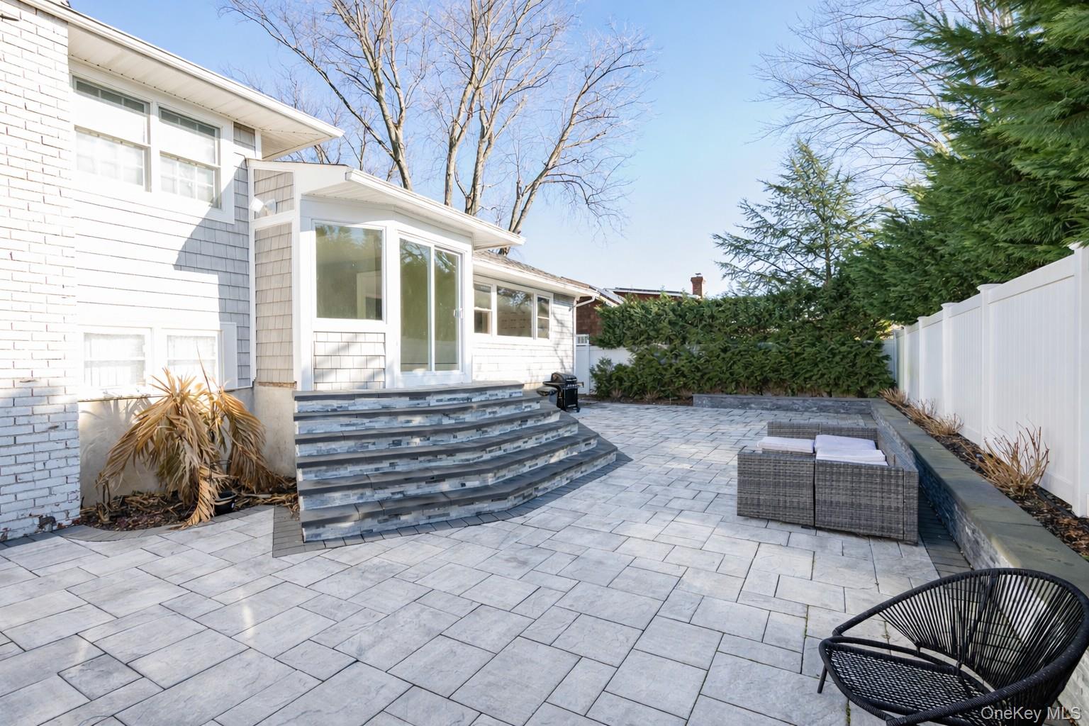 148 Exeter Road Massapequa, NY 11758 - Photo 27 of 28 a front view of a house with a garden