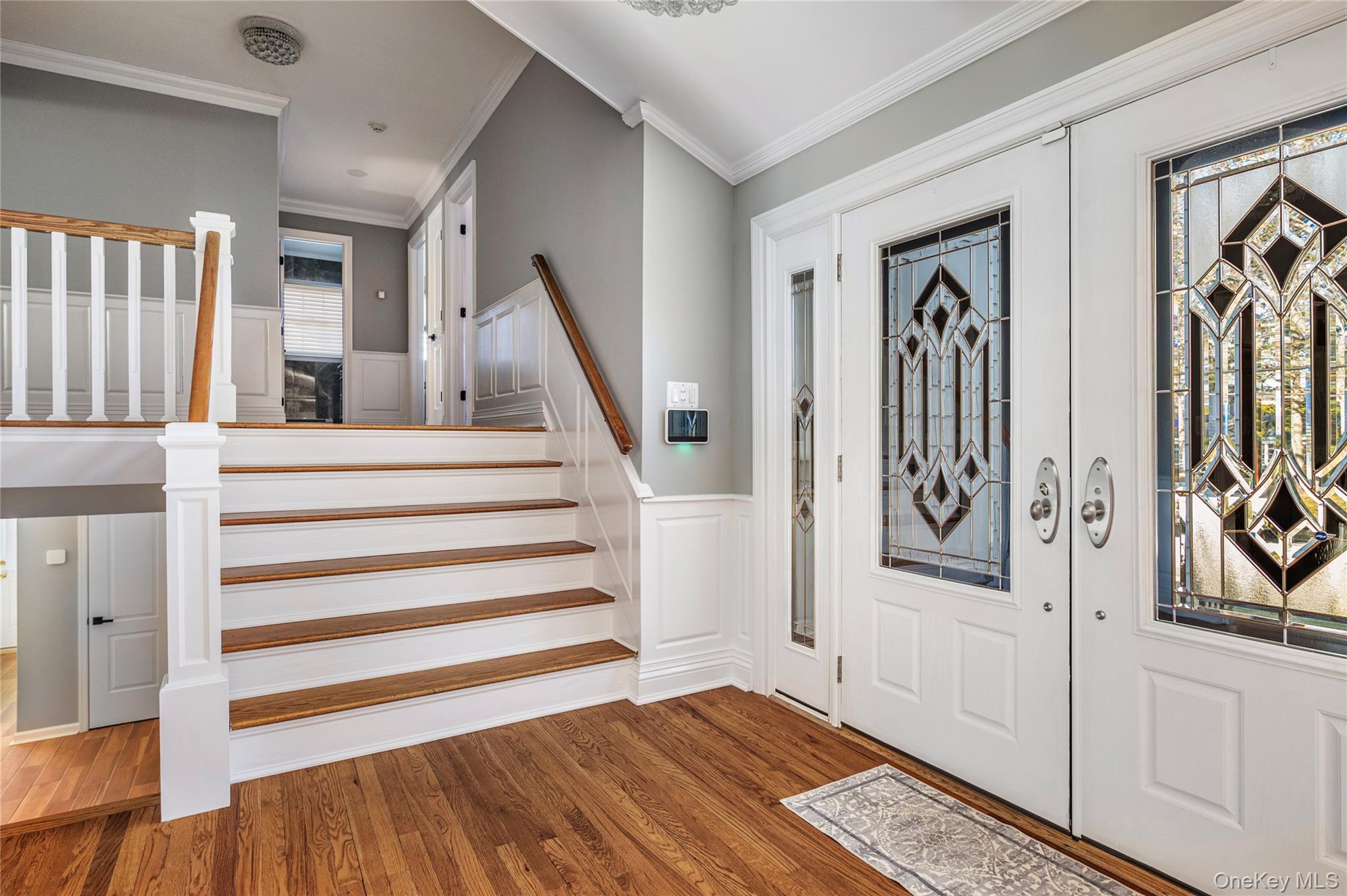 148 Exeter Road Massapequa, NY 11758 - Photo 9 of 28 a view of a hallway with wooden floor and staircase