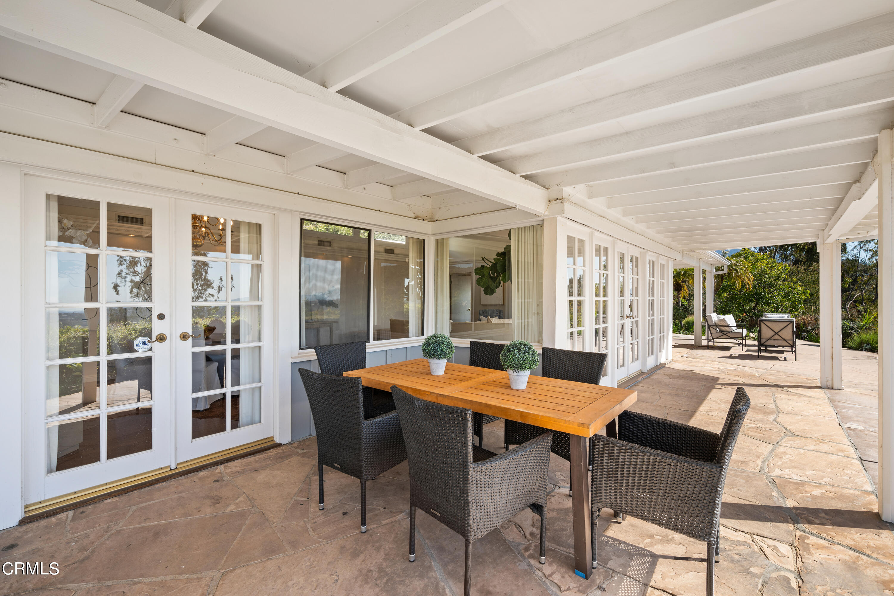 1444 Normandy Drive Pasadena, CA 91103 - Photo 19 of 25 a view of a patio with table and chairs and potted plants