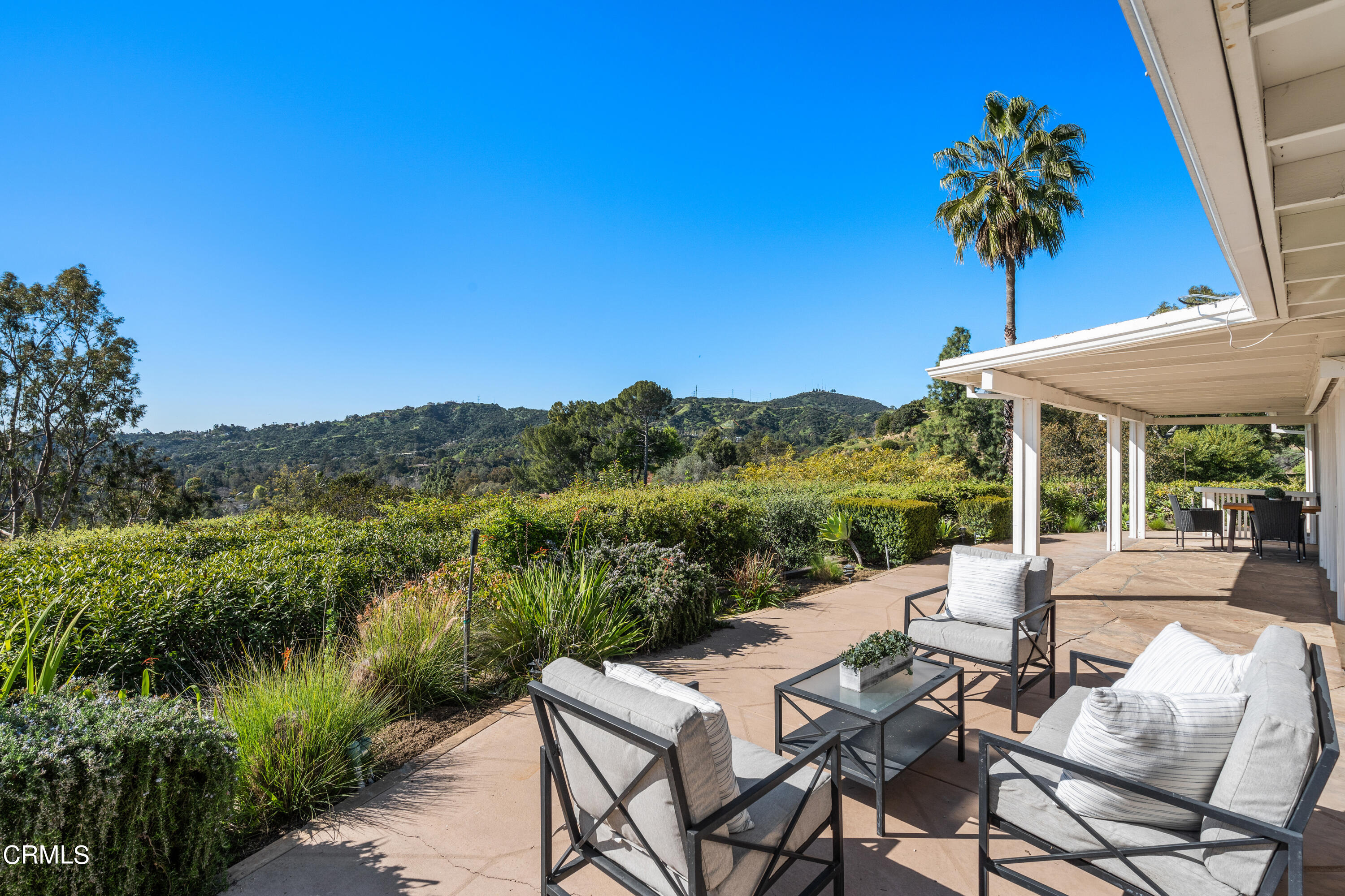 1444 Normandy Drive Pasadena, CA 91103 - Photo 22 of 25 a view of a lake with a table and chairs under an umbrella