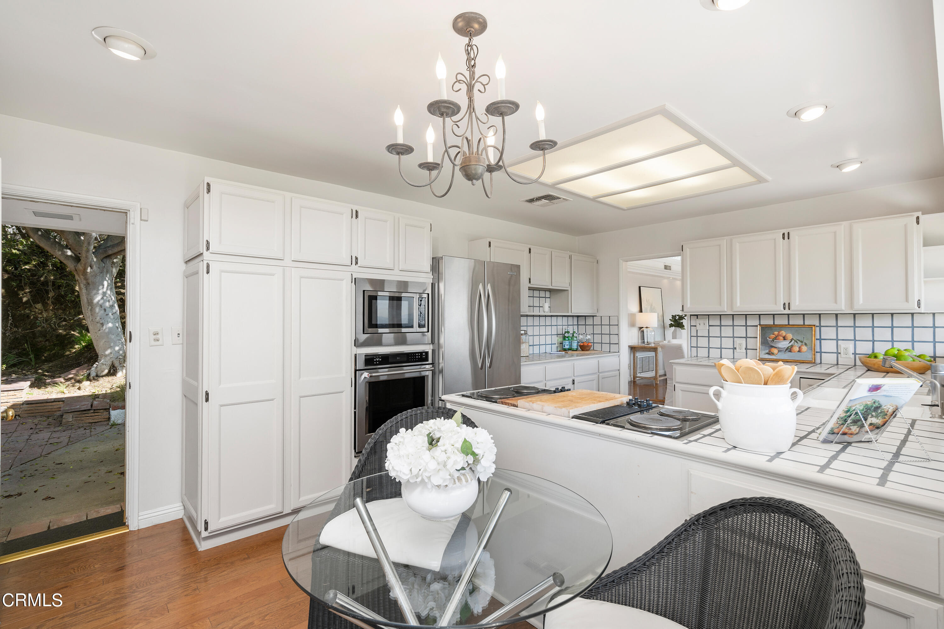 1444 Normandy Drive Pasadena, CA 91103 - Photo 8 of 25 a kitchen with stainless steel appliances kitchen island granite countertop a refrigerator a stove a microwave oven with a dining table and chairs