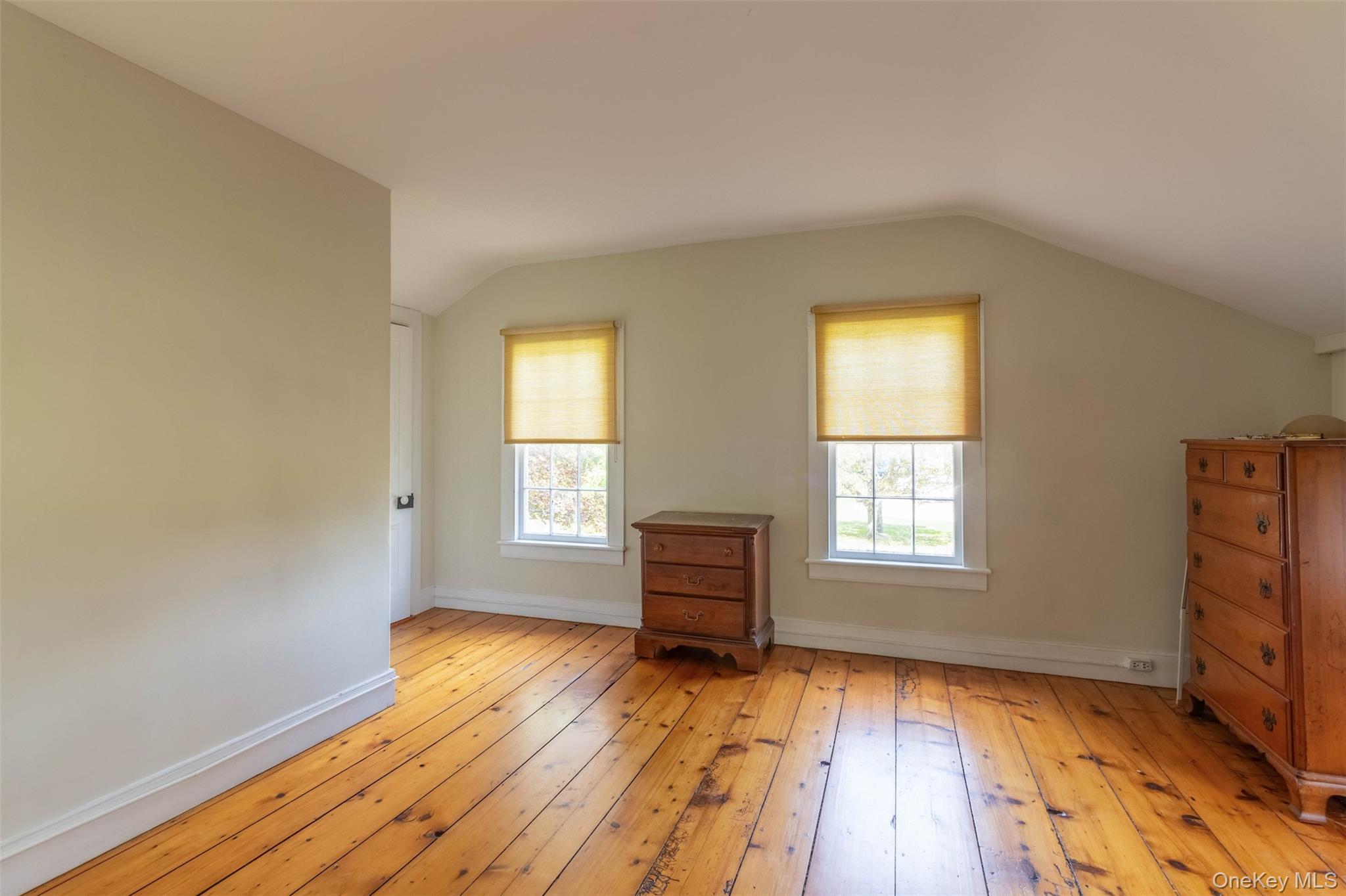 19450 Main Road Mattituck, NY 11952 - Photo 13 of 16 Bonus room with light wood finished floors and vaulted ceiling