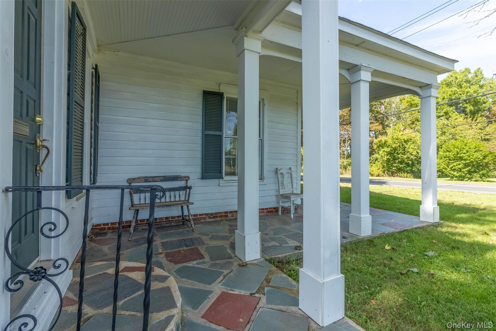 19450 Main Road Mattituck, NY 11952 - Photo 16 of 16 Covered porch featuring a lawn