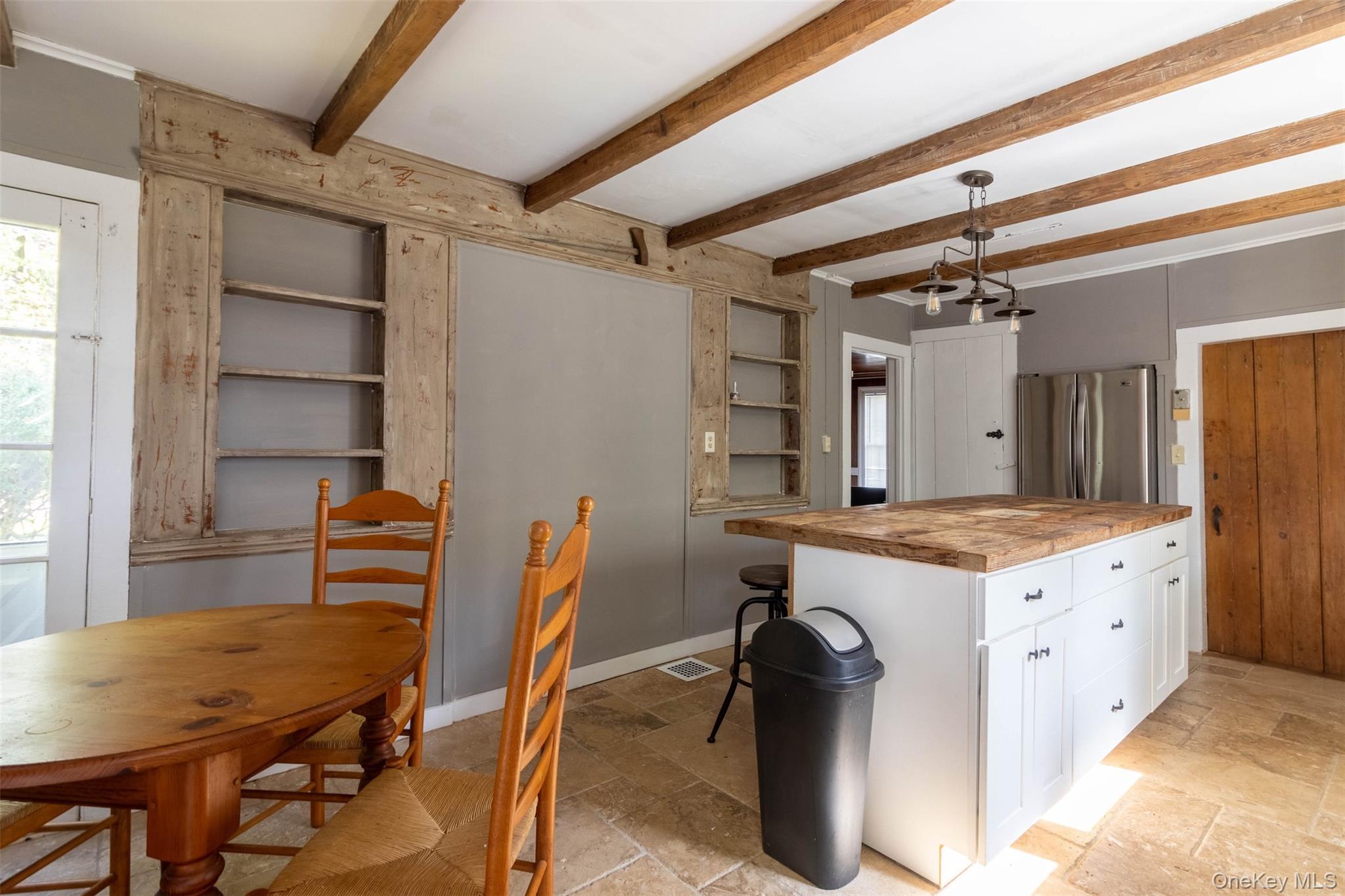 19450 Main Road Mattituck, NY 11952 - Photo 2 of 16 Kitchen with wooden counters, white cabinetry, freestanding refrigerator, pendant lighting, and stone tile floors