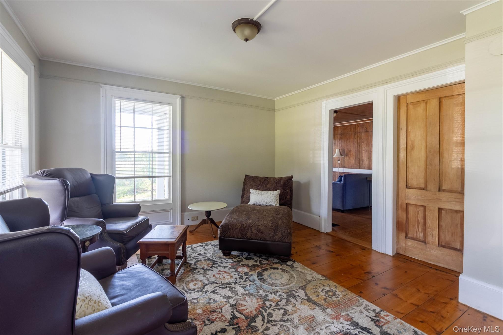 19450 Main Road Mattituck, NY 11952 - Photo 8 of 16 Living area featuring wood-type flooring and ornamental molding