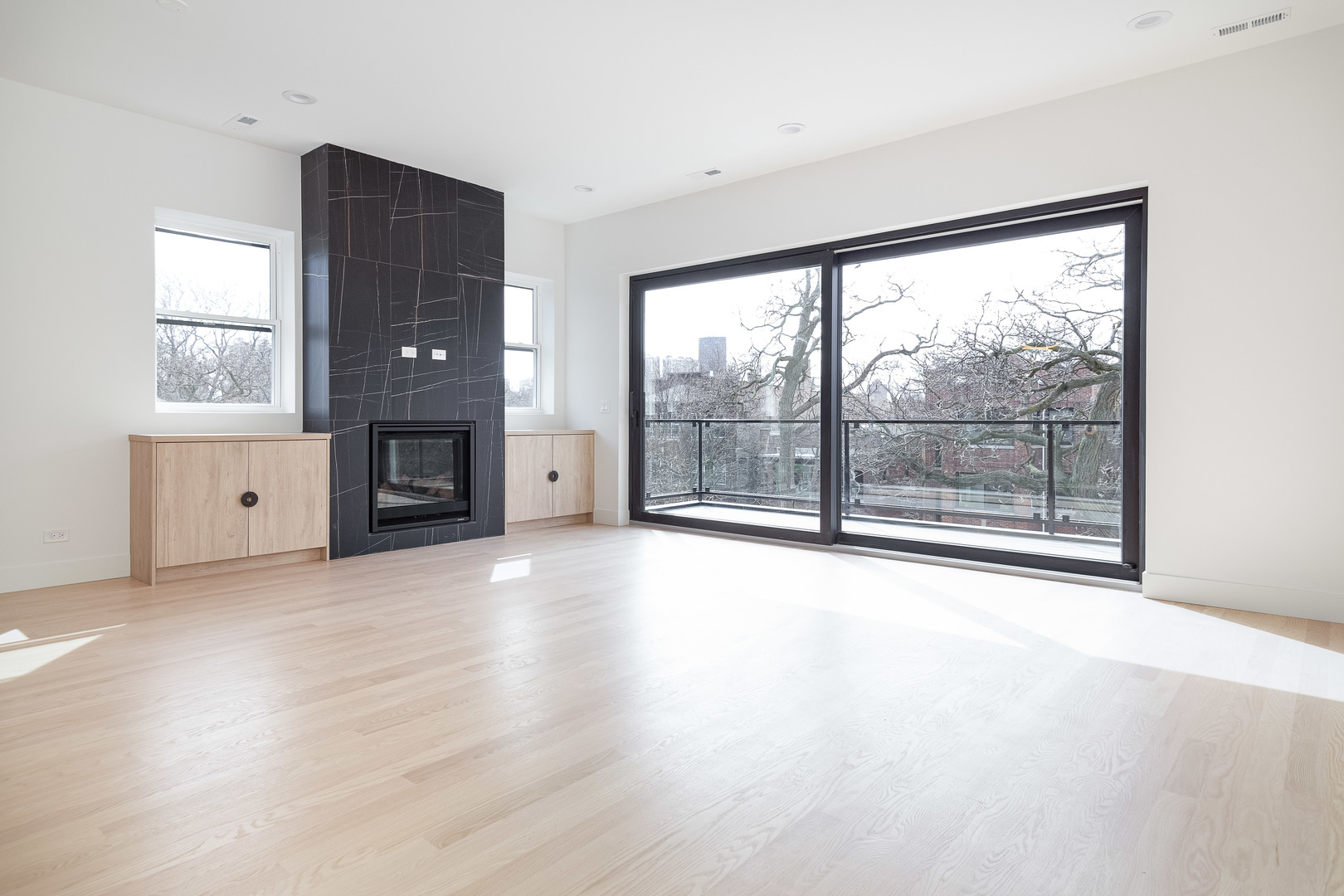 1334 West Rosedale Avenue, Unit 3 Chicago, IL 60660 - Photo 7 of 24 an empty room with fireplace and windows