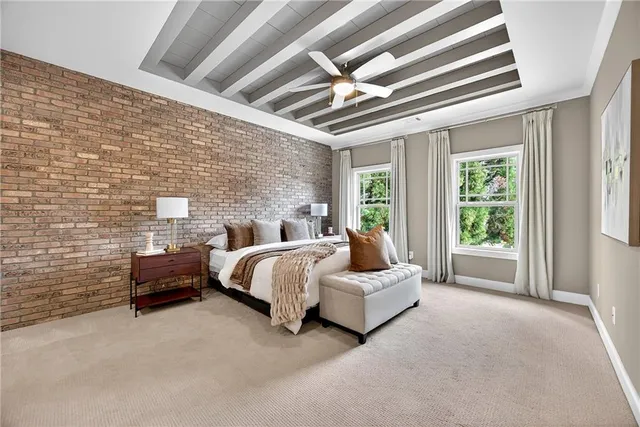 a spacious bedroom with a bed and a large window