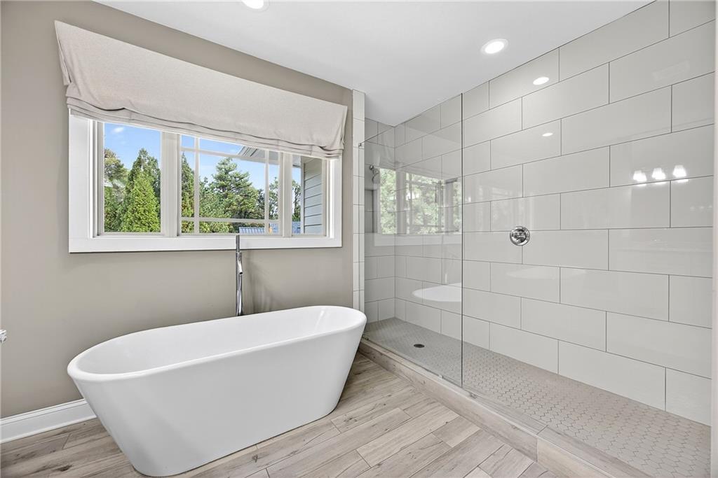 2675 Sugar Mill Drive Southeast Atlanta, GA 30316 - Photo 18 of 38 a white bath tub sitting in a bathroom next to a window