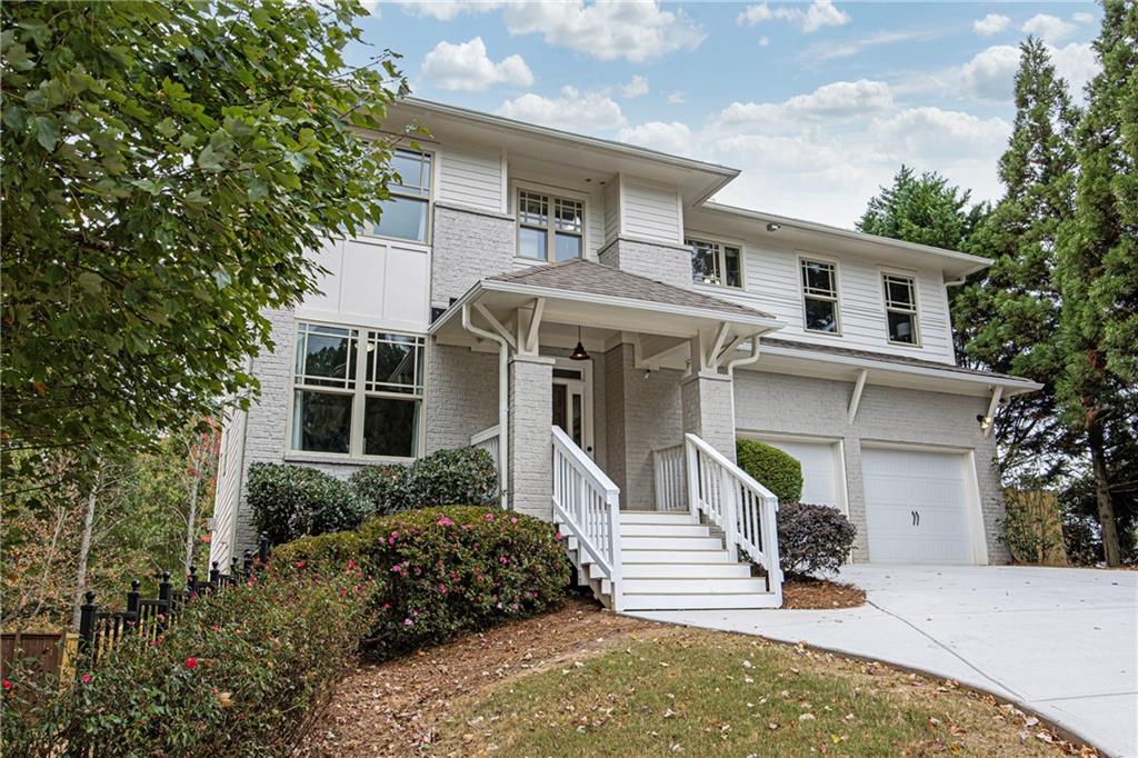 2675 Sugar Mill Drive Southeast Atlanta, GA 30316 - Photo 2 of 38 a front view of a house with a yard