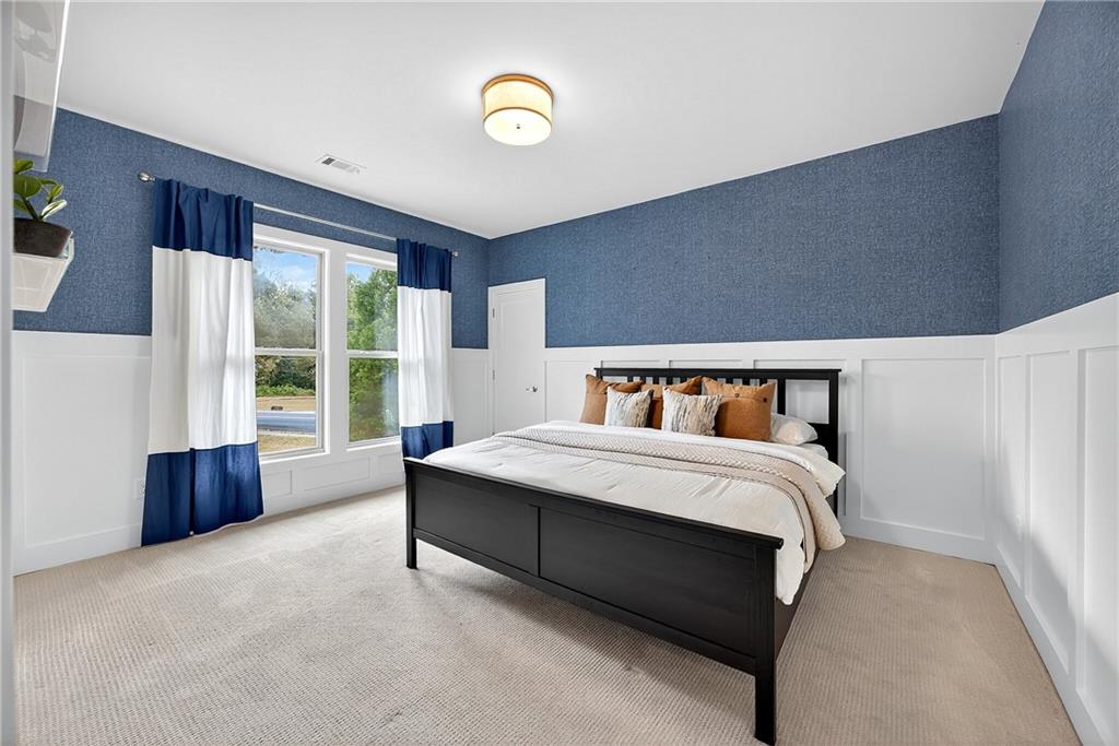 2675 Sugar Mill Drive Southeast Atlanta, GA 30316 - Photo 23 of 38 a spacious bedroom with a bed and a large window
