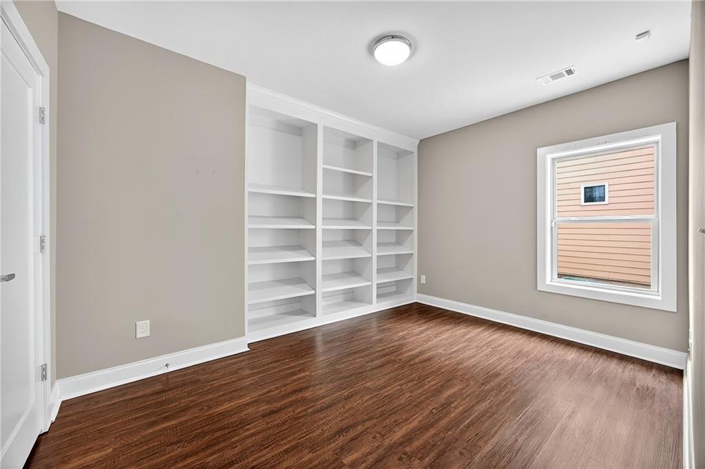 2675 Sugar Mill Drive Southeast Atlanta, GA 30316 - Photo 28 of 38 a view of an empty room with a window and wooden floor