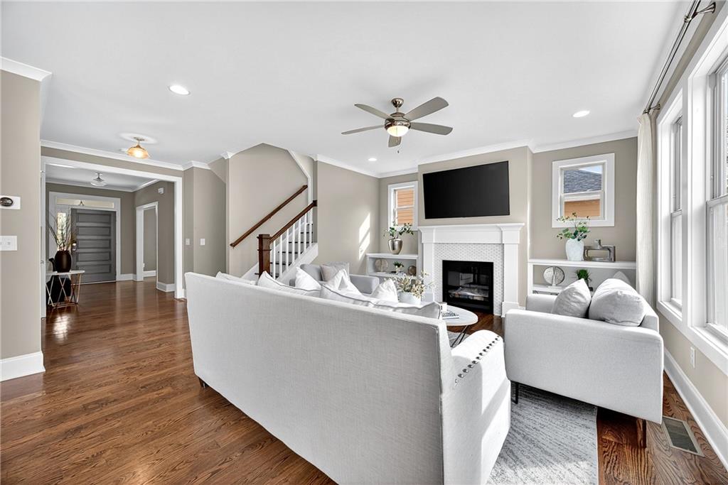 2675 Sugar Mill Drive Southeast Atlanta, GA 30316 - Photo 8 of 38 a living room with furniture a fireplace and a flat screen tv
