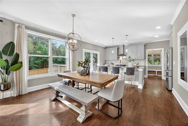 a dining room with furniture and wooden floor