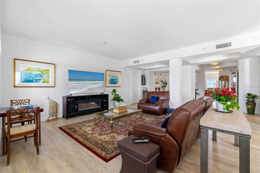 606 Riviera Dunes Way, Unit 601 Palmetto, FL 34221 - Photo 12 of 70 a living room with furniture a fireplace and a flat screen tv