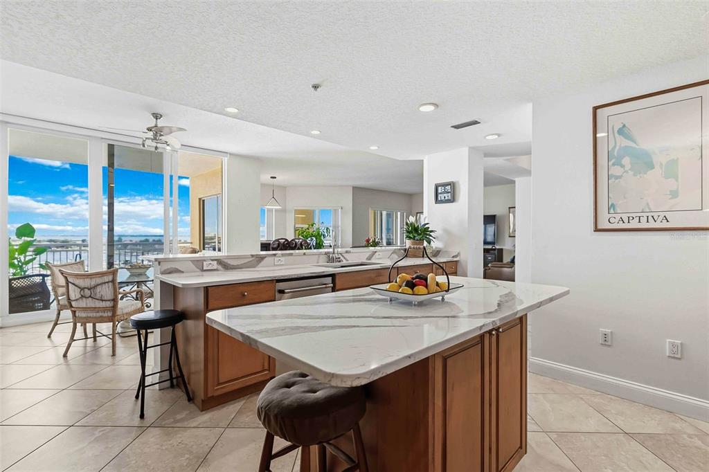 606 Riviera Dunes Way, Unit 601 Palmetto, FL 34221 - Photo 13 of 70 a view of kitchen island dining table and chairs