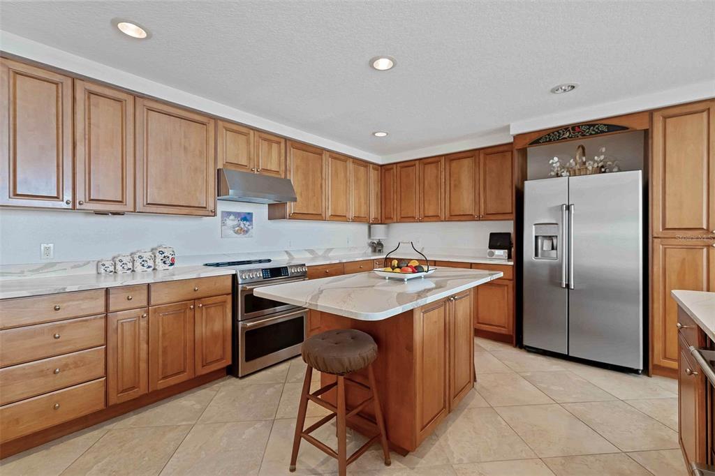 606 Riviera Dunes Way, Unit 601 Palmetto, FL 34221 - Photo 16 of 70 a kitchen with a sink a refrigerator and a cabinets