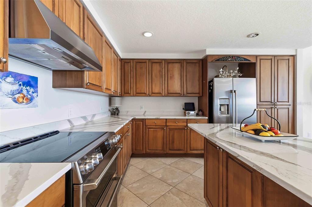 606 Riviera Dunes Way, Unit 601 Palmetto, FL 34221 - Photo 17 of 70 a kitchen with stainless steel appliances granite countertop a sink stove and cabinets