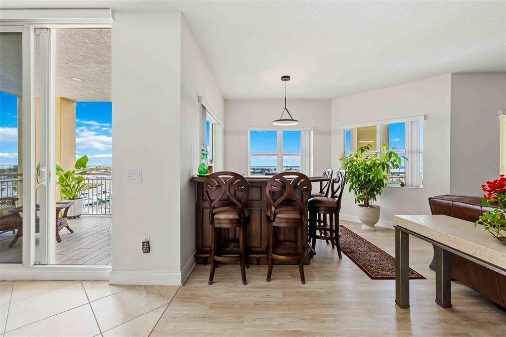606 Riviera Dunes Way, Unit 601 Palmetto, FL 34221 - Photo 19 of 70 a view of a dining room with furniture and a potted plant