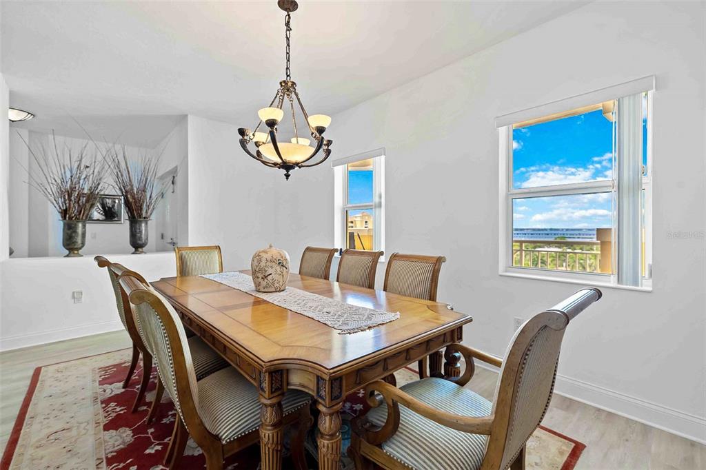 606 Riviera Dunes Way, Unit 601 Palmetto, FL 34221 - Photo 25 of 70 a view of a dining room with furniture window and wooden floor