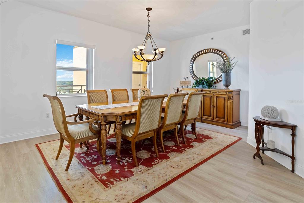 606 Riviera Dunes Way, Unit 601 Palmetto, FL 34221 - Photo 26 of 70 a view of a dining room with furniture window and wooden floor