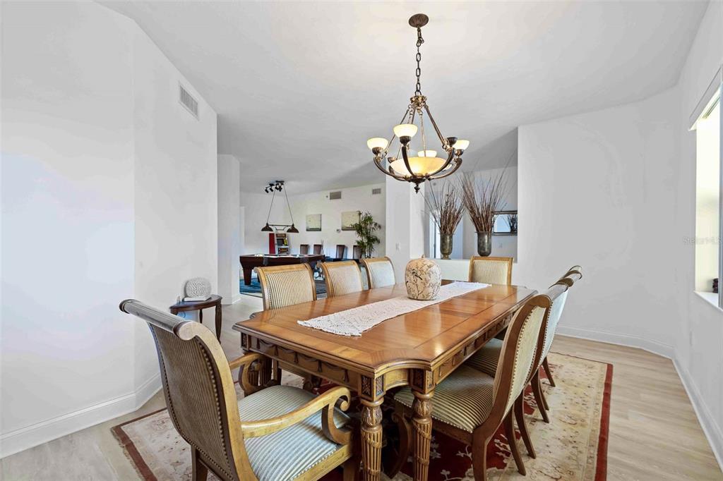 606 Riviera Dunes Way, Unit 601 Palmetto, FL 34221 - Photo 27 of 70 a view of a dining room and a livingroom with furniture wooden floor a chandelier
