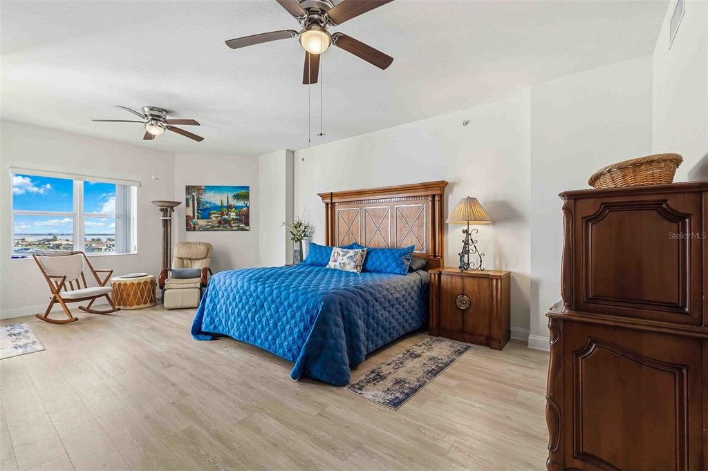 606 Riviera Dunes Way, Unit 601 Palmetto, FL 34221 - Photo 30 of 70 a bedroom with a bed and wooden floor