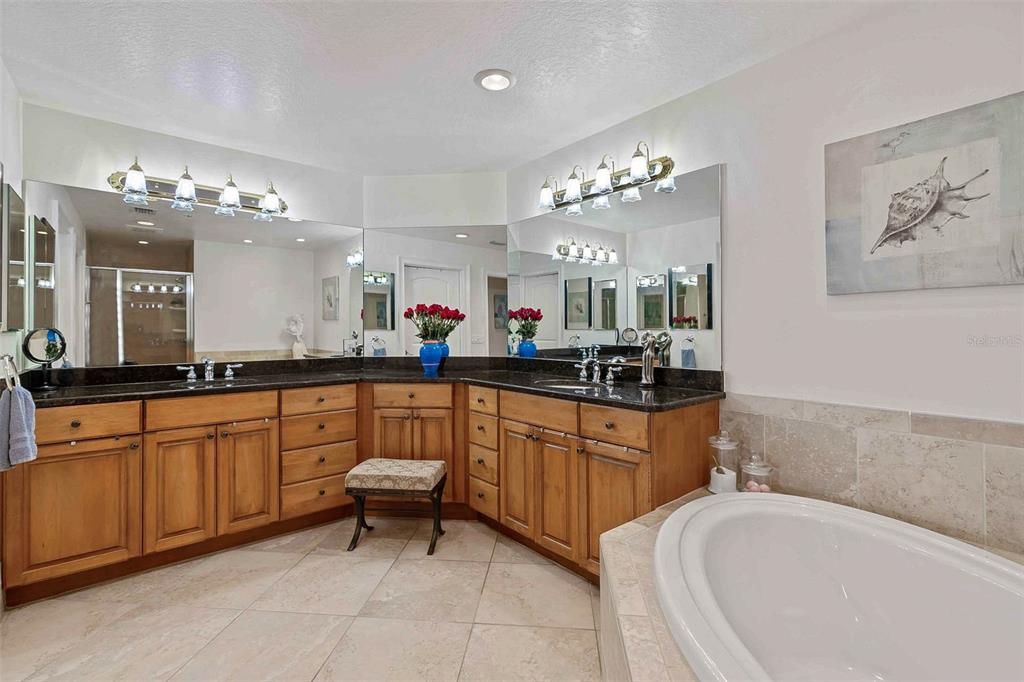 606 Riviera Dunes Way, Unit 601 Palmetto, FL 34221 - Photo 33 of 70 a large white bathroom with a large tub sink and cabinets