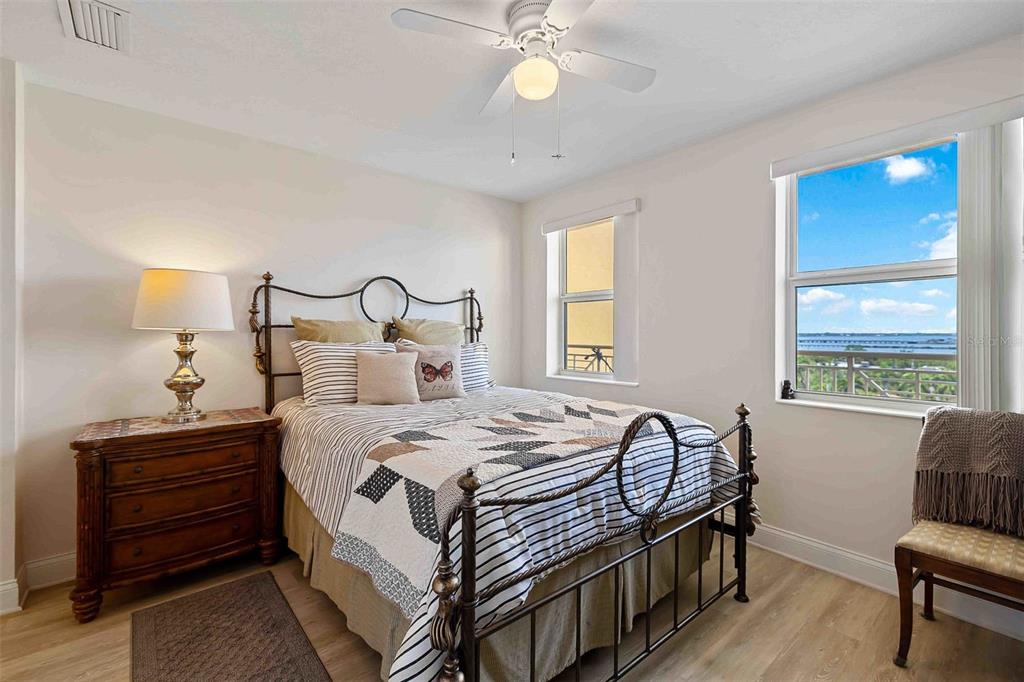 606 Riviera Dunes Way, Unit 601 Palmetto, FL 34221 - Photo 34 of 70 a bedroom with a bed and a chandelier