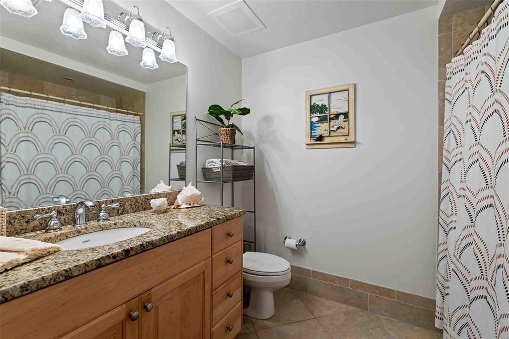 606 Riviera Dunes Way, Unit 601 Palmetto, FL 34221 - Photo 41 of 70 a bathroom with a granite countertop toilet sink and mirror