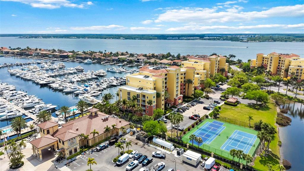 606 Riviera Dunes Way, Unit 601 Palmetto, FL 34221 - Photo 53 of 70 an aerial view of a city with lots of residential buildings ocean and mountain view in back