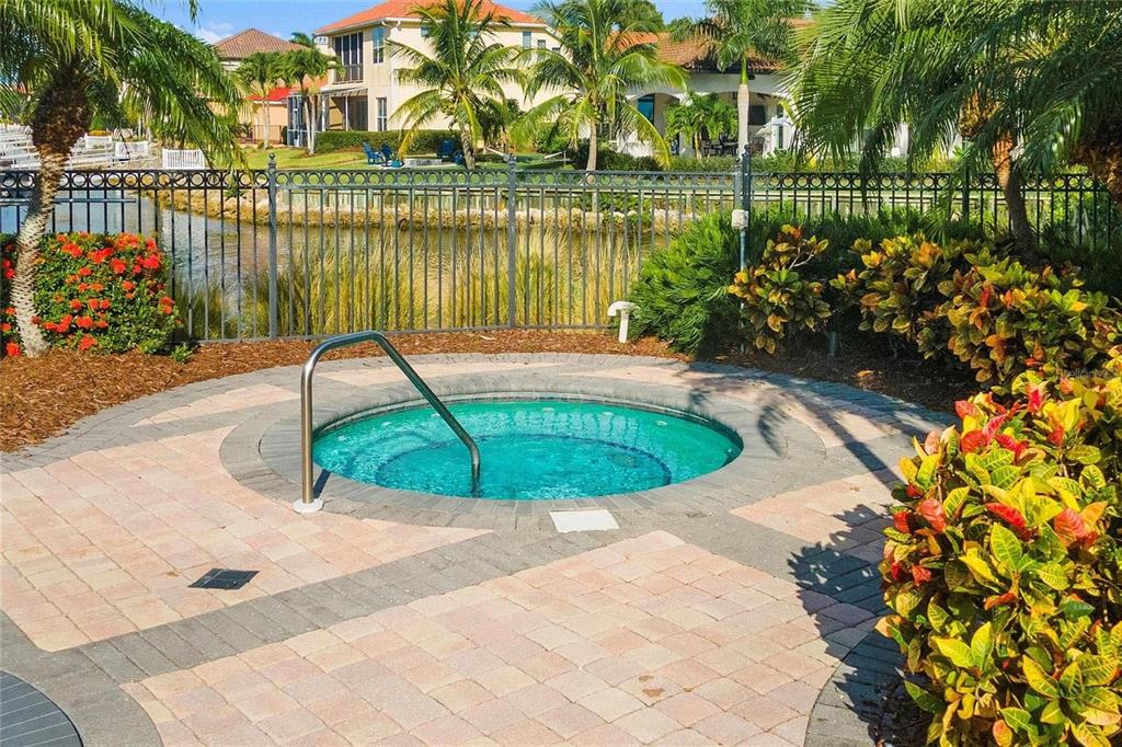 606 Riviera Dunes Way, Unit 601 Palmetto, FL 34221 - Photo 65 of 70 a view of a swimming pool with a patio and a lake view