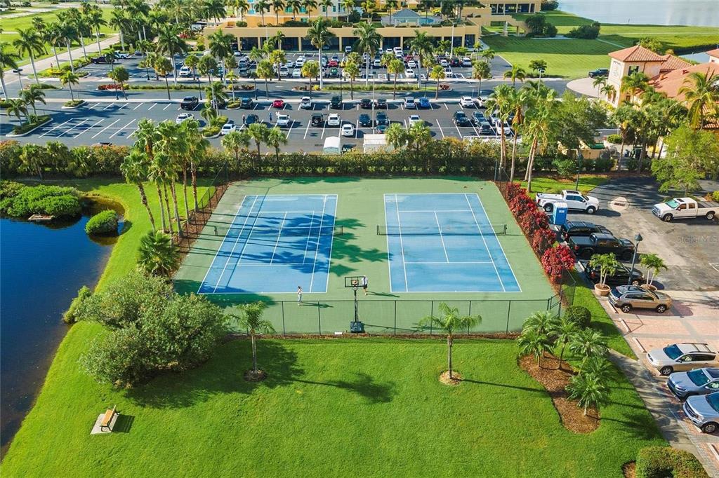 606 Riviera Dunes Way, Unit 601 Palmetto, FL 34221 - Photo 66 of 70 an aerial view of a house with a yard and lake view