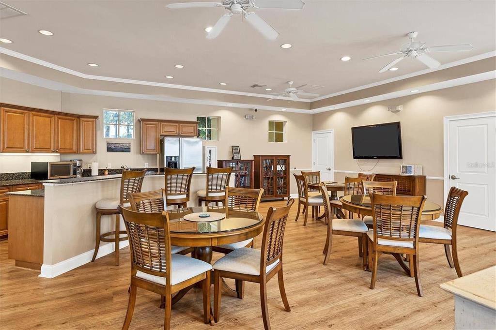 606 Riviera Dunes Way, Unit 601 Palmetto, FL 34221 - Photo 69 of 70 a view of a dining room with furniture and wooden floor