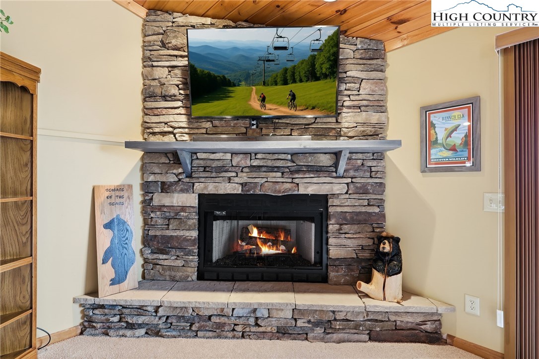 112 North Pinnacle Ridge Road Beech Mountain, NC 28604 - Photo 11 of 40 a fireplace with a clock on top of it