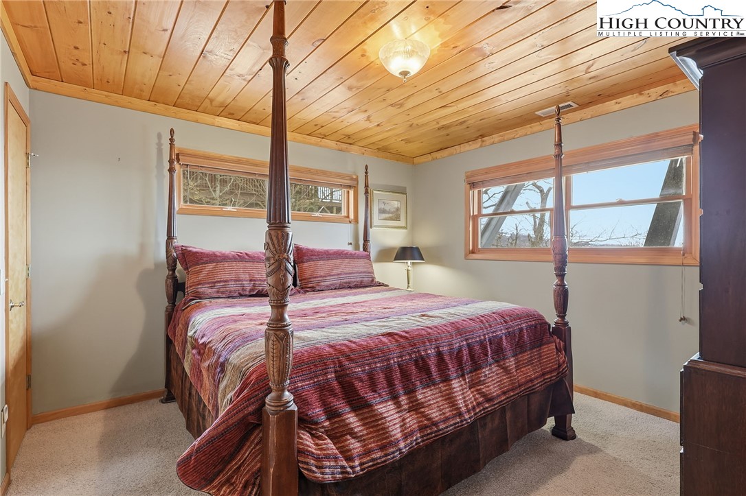 112 North Pinnacle Ridge Road Beech Mountain, NC 28604 - Photo 29 of 40 a bedroom with a bed and window