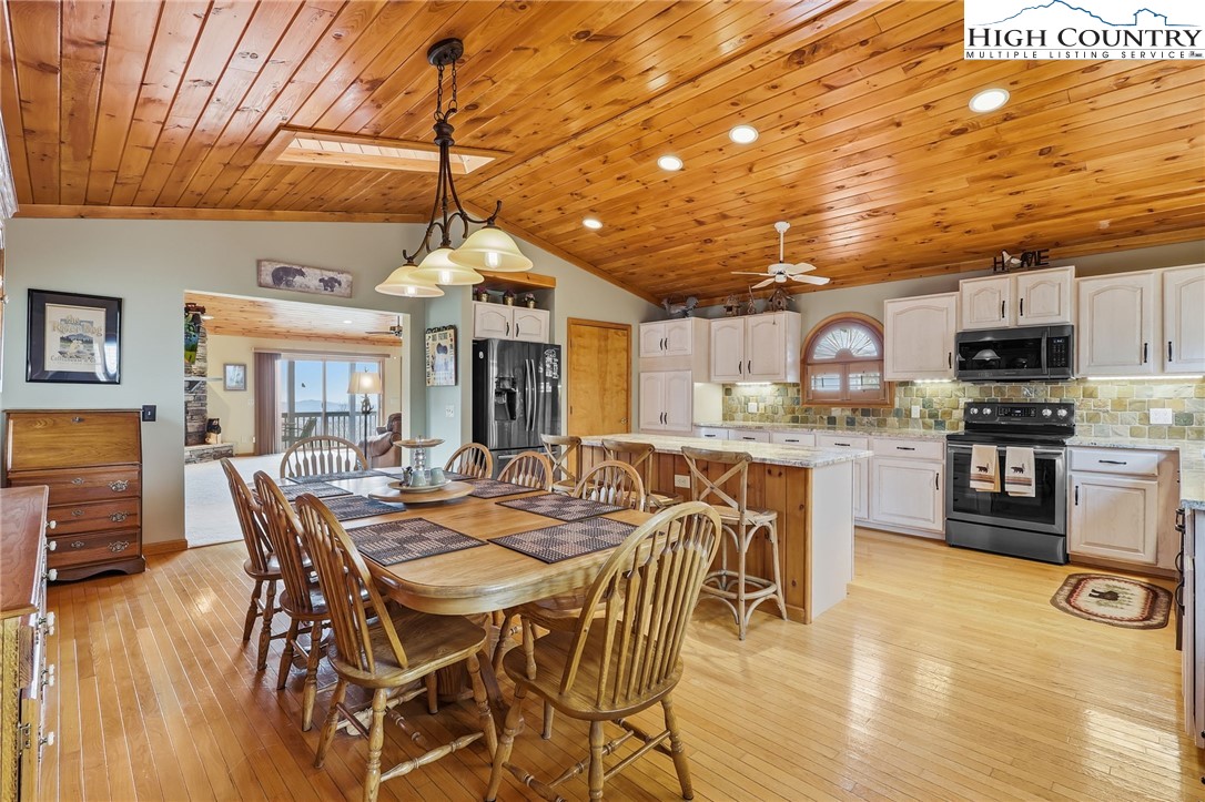 112 North Pinnacle Ridge Road Beech Mountain, NC 28604 - Photo 5 of 40 a view of a dining room with furniture and wooden floor