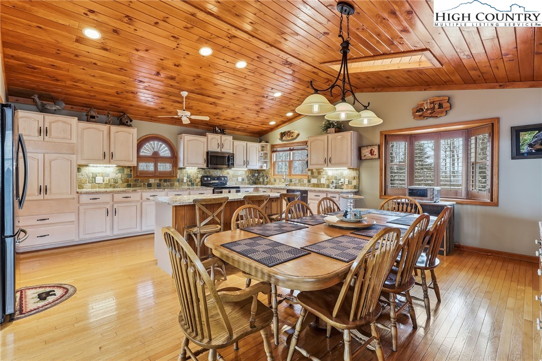 112 North Pinnacle Ridge Road Beech Mountain, NC 28604 - Photo 6 of 40 a view of a dining room with furniture window and wooden floor