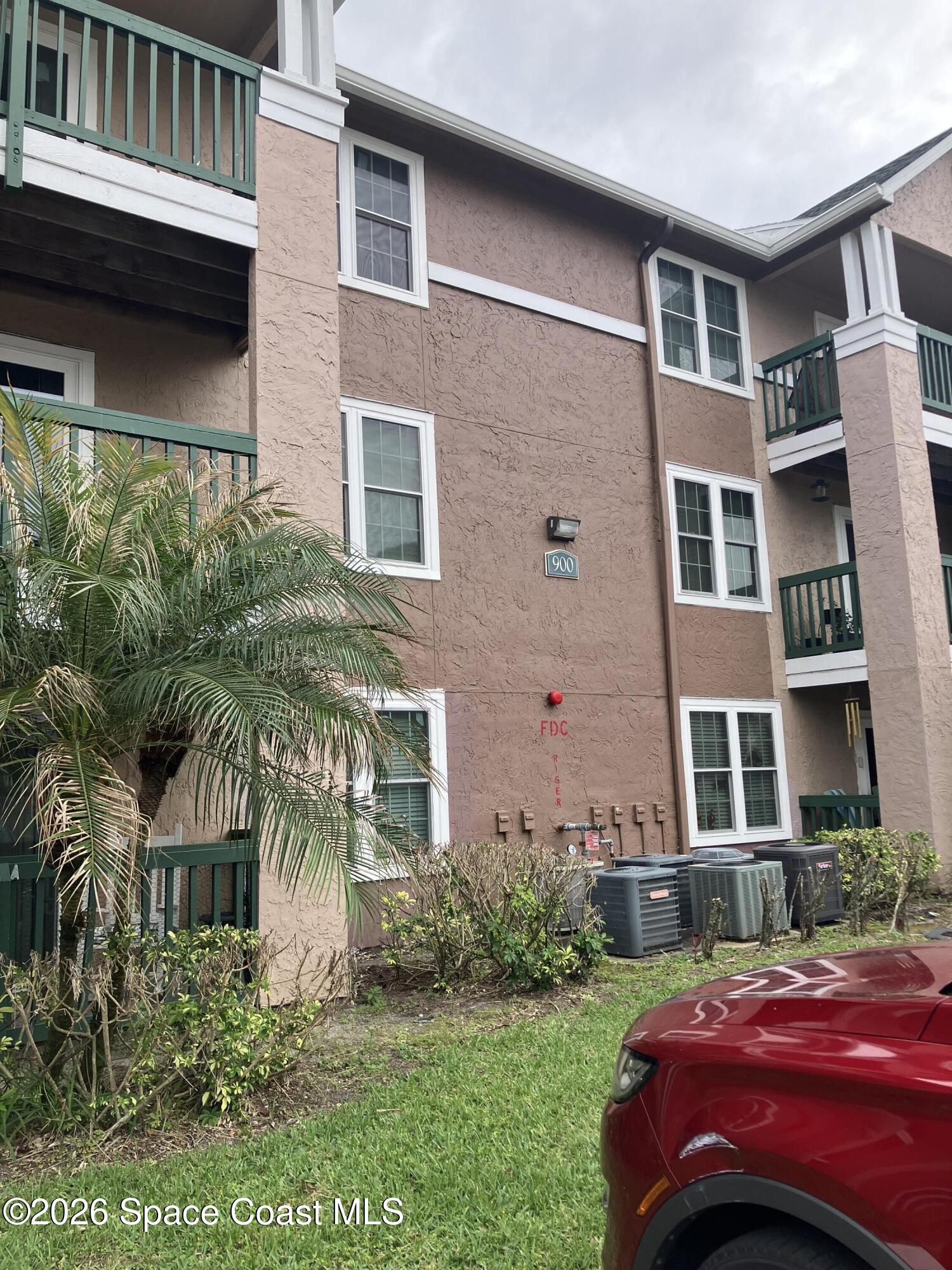 7667 North Wickham Road, Unit 917 Melbourne, FL 32940 - Photo 1 of 18 a front view of a house with a yard