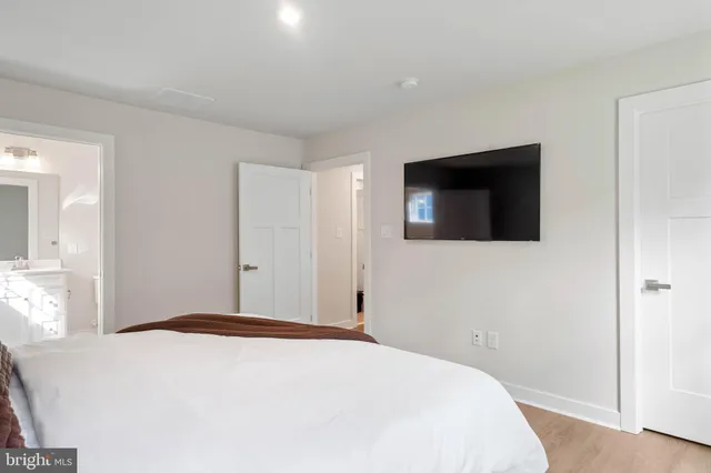 a bedroom with a bed and a flat screen tv