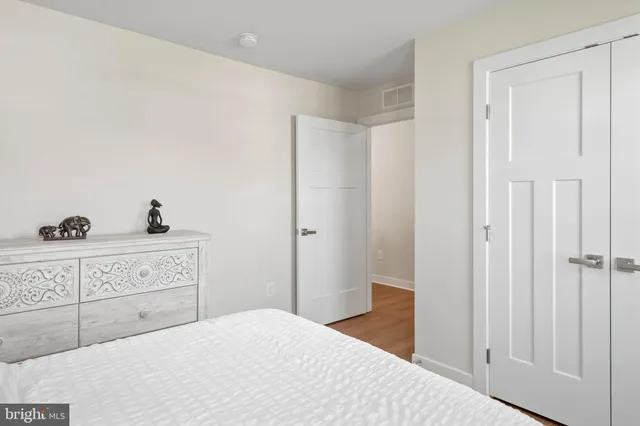 a bedroom with a bed and cabinet