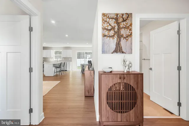 a view of entryway and hall with wooden floor
