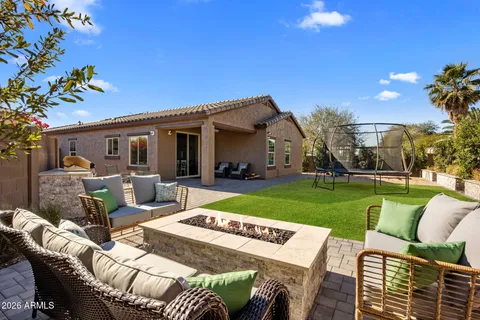 a view of a house with backyard and sitting area