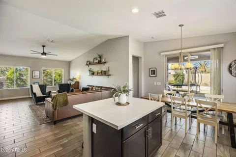 a kitchen with refrigerator cabinets dining table and chairs