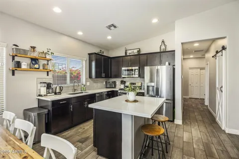 a kitchen with a sink appliances and cabinets