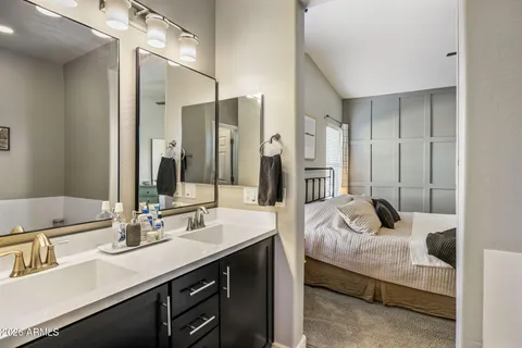 a bathroom with a tub sink and mirror
