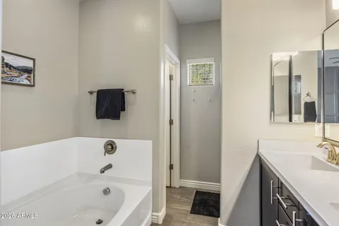 a bedroom that has a bed and a dresser in it